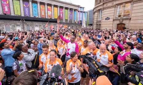 Sir Lenny Henry takes part in the baton relay as it arrives in Birmingham.