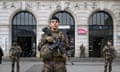 French soldiers patrol outside Saint Lazare railway station in Paris