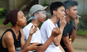 High school students smoke cigarettes after class in Bogor, Indonesia.