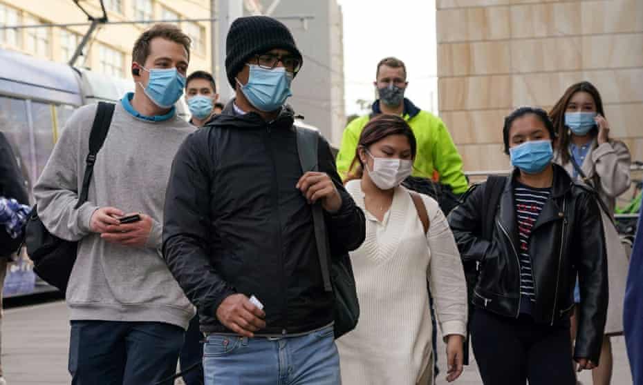 Commuters wear face masks as they enter Sydney's Central Station