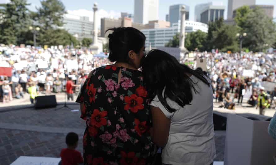 Brenda Villa, left, comforts her 11-year-old daughter, Kathryn, after speaking during an immigration rally and protest in Civic Center Park Saturday, June 30, 2018, in downtown Denver.