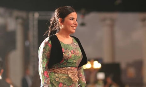 Zehra Doğan wearing green dress and smiling
