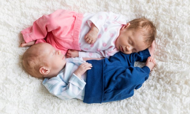 two babies, one in blue, one in pink