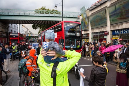 Environmental activists from Stop Killing Londoners and Mums for Lungs block Brixton Road at rush hour.