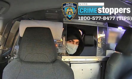 a man in the backseat of a cab wearing a mask