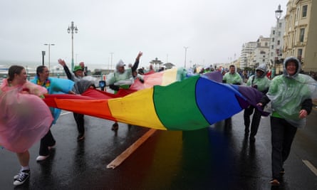 Marchers struggling to carry a Pride flag