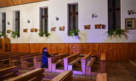 woman praying in a church.