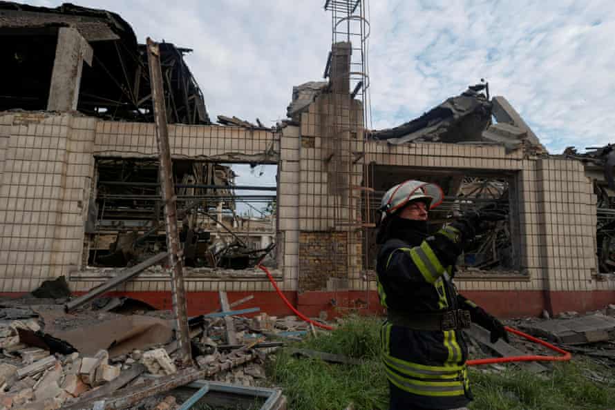 A rescuer at the Darnytsia car repair plant in Kyiv, damaged by missile strikes on Sunday