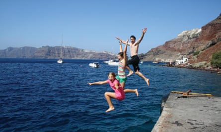 Justin Yerbury and his daughters leap off the caldera in Santorini, Greece in 2009