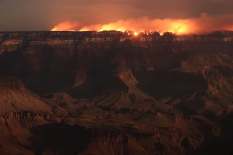 a fire burns in the grand canyon