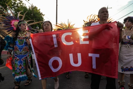 people clasp a banner that sounds ‘ice out’