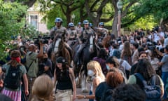 Texas state troopers on horseback work to disperse students at the University of Texas at Austin