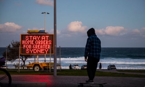 sign at bondi beach saying 'stay-at-home' orders for greater sydney