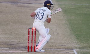 England's Jos Buttler steps back into his own stumps to bring a strange end to a dogged innings.