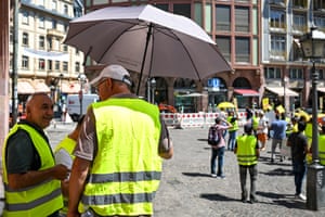 Frankfurt, GermanyA man protects himself from the heat with an umbrella during a demonstration in Frankfurt