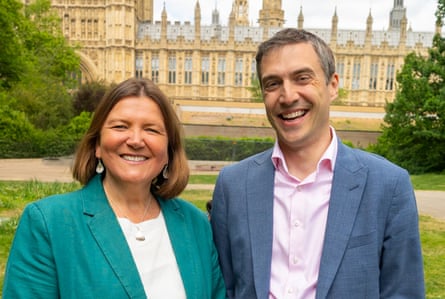 Ellie Chowns and Adrian Ramsay posing together outside the Houses of Parliament