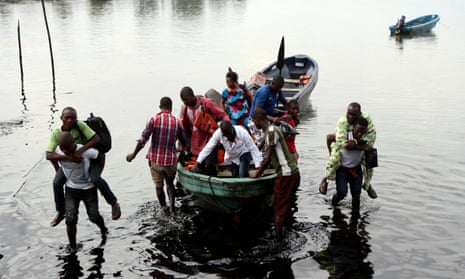 Boat guides carry people through polluted water in Ogoniland