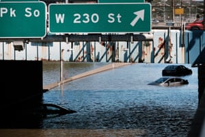 Cars sit abandoned on the flooded Major Deegan Expressway in the Bronx borough of New York City