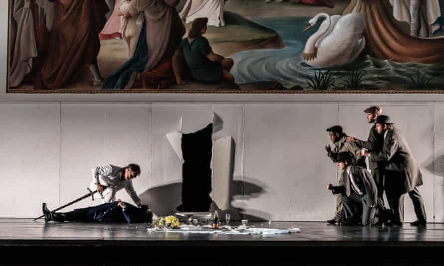 Brandon Jovanovich (kneeling) as Lohengrin under the Swan Knight mural.