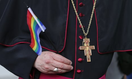 A member of the Catholic clergy carries a gay pride flag in Havana, Cuba, in May 2015. 