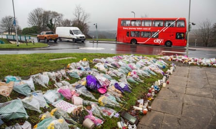 Flowers remain at the bus stop in Plymouth, Devon, where Bobbi-Anne McLeod was last seen alive.