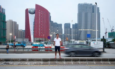 Daniel Yan standing outside The 13 Hotel surrounded by ordinary apartment buildings in Macau’s Coloane neighbourhood