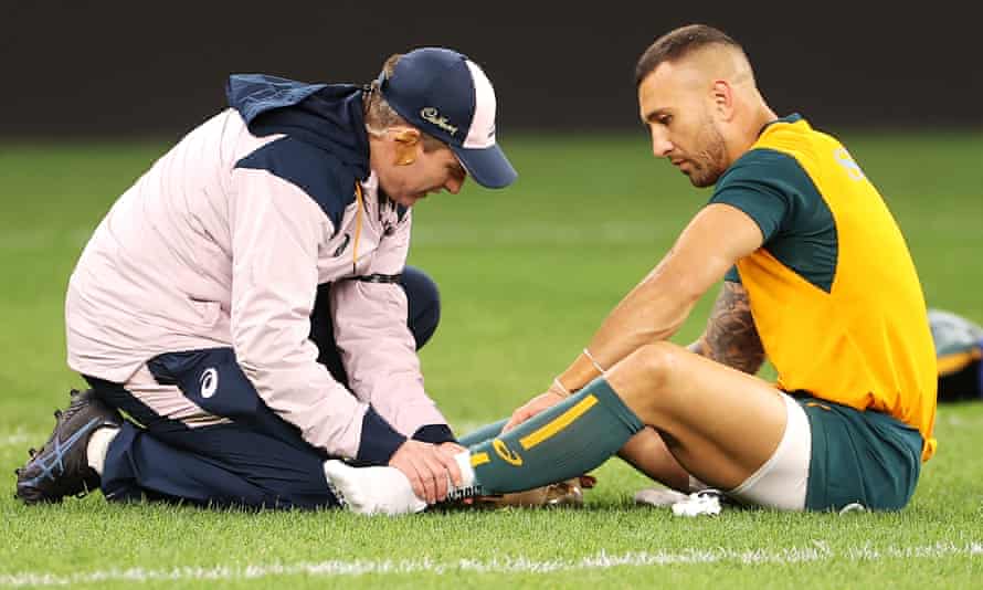 Quade Cooper of the Wallabies receives attention from the trainer during the warm-up.