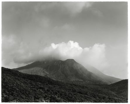 Clouds envelop a barren volcanic landscape