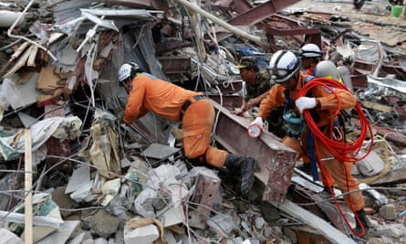 Rescue workers search for victims in the debris a day after an under-construction building collapsed in Sihanoukville.