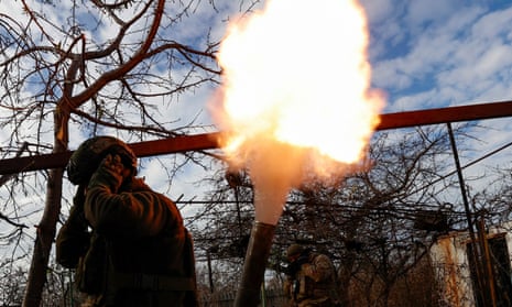 Members of Ukraine’s National Guard fire a mortar toward Russian troops in the frontline town of Avdiivka