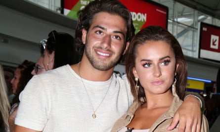 Happy landings: Love Island’s Kem Cetinay and Amber Davies at Stansted airport this summer.