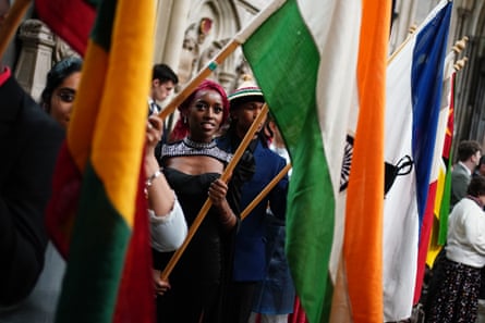 A woman’s face is seen through a line of flags