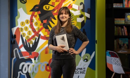 Victoria, the owner of the bookshop holding her favorite Skovoroda book in Podil, Ukraine.