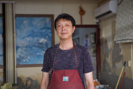 Wang Wei-chang stands on the ground floor of his parents home in Guangfu.