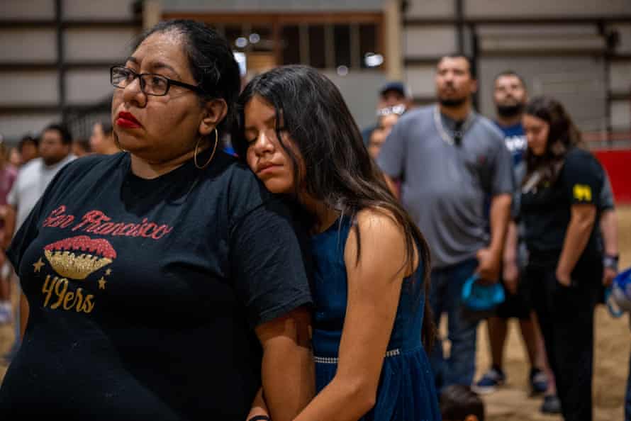 Families stand together at a vigil for the victims in the mass shooting at Rob Elementary School.