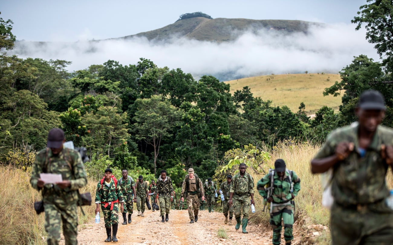 A rifleman of the 2nd battalion The Rifles regiment walks with Gabon national park rangers.