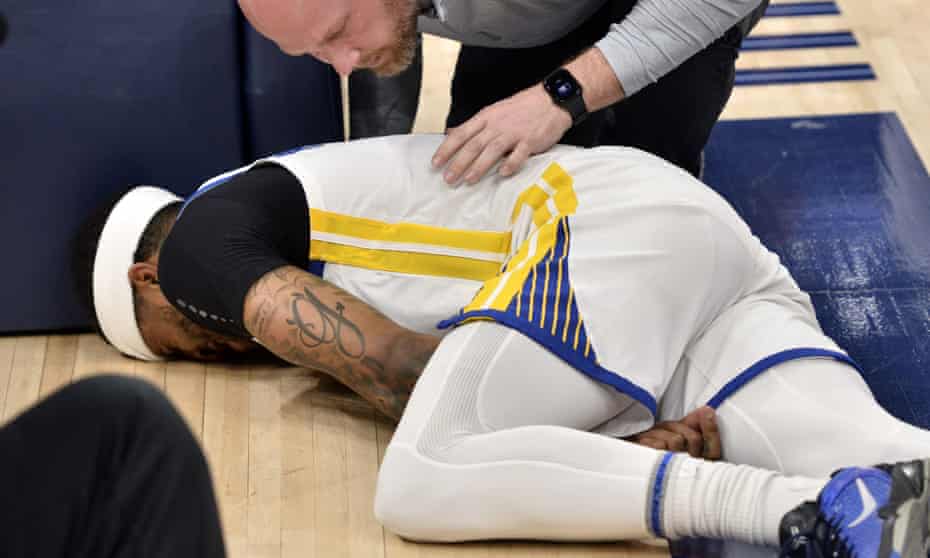 Golden State Warriors guard Gary Payton II lies on the court after being fouled during the first half of Game 2