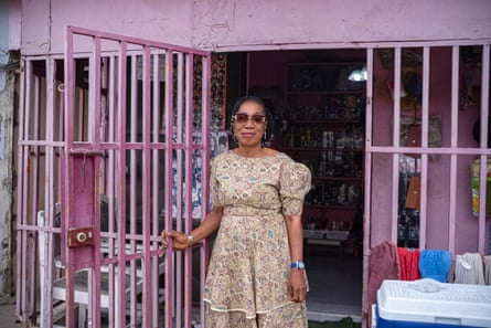 Thérèse Gueu stands outside her pink hair salon.