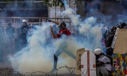 Opposition protesters clash with Venezuela security forces in Caracas on Saturday.