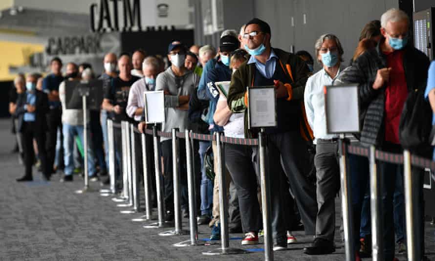 People wait in a line for a Covid vaccination at the Melbourne Convention and Exhibition Centre