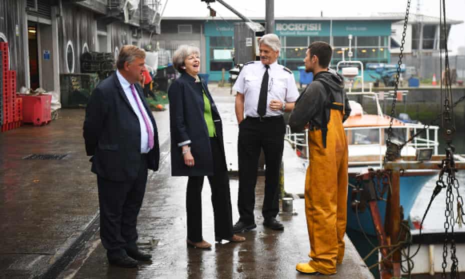 Theresa May is amused as she visits Plymouth fisheries on Wednesday.