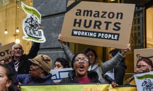 People opposed to Amazon’s plan to locate a headquarters in New York City hold a protest outside of an Amazon book store on 26 November in NYC.