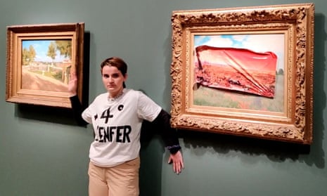 A climate activist poses after defacing the painting at the Musée d’Orsay