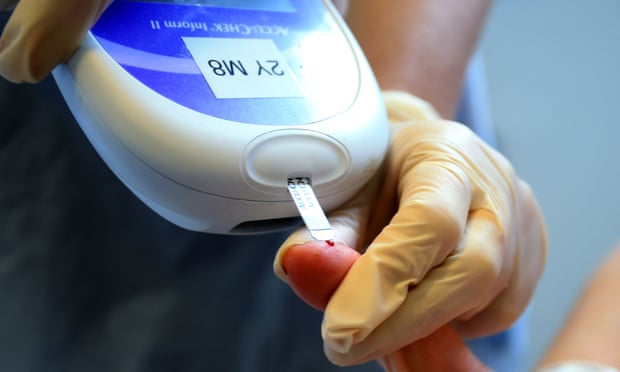 A nurse tests a patient for diabetes