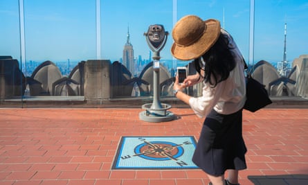 young woman taking a photo of the Rockefeller Center Observation Deck