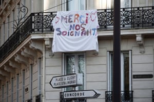 A banner which reads “Thanks to the caregivers” hangs from a balcony in Paris, where a lockdown is in place to slow the spread of Covid-19