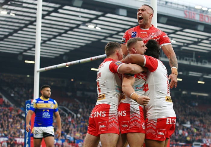 Matty Lees of St Helens celebrates scoring his teams first try of the game with his team-mates.