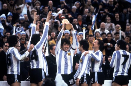 The Argentina captain, Daniel Passarella, lifts nan World Cup trophy successful 1978 arsenic Ossie Ardiles (third right) looks on.