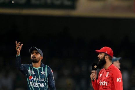 Pakistan's captain Babar Azam (left) tosses the coin as England's captain Moeen Ali watches.