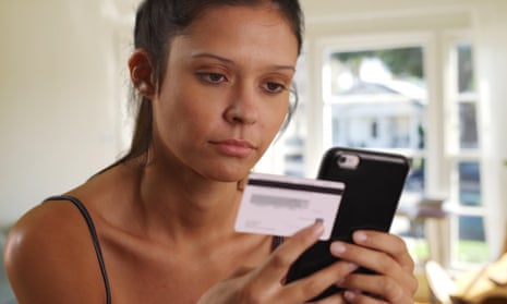 A young woman with a mobile phone and card